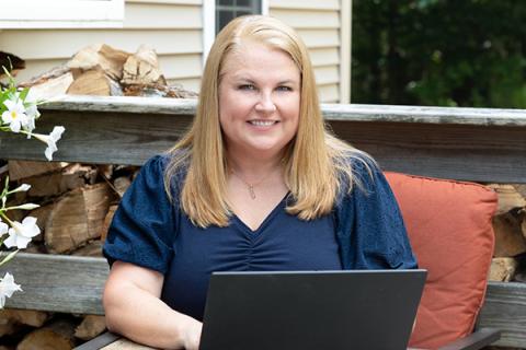 Marlene on laptop outside